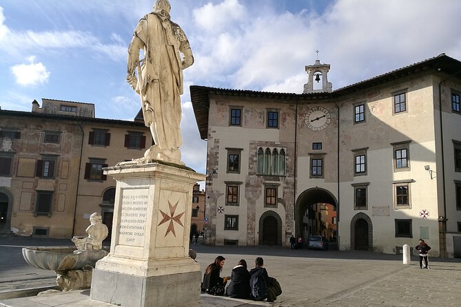 Cycling Pisa highlights & hidden treasures - half day tour - Piazza Giuseppe Garibaldi: students, a grand building, and a carved detail